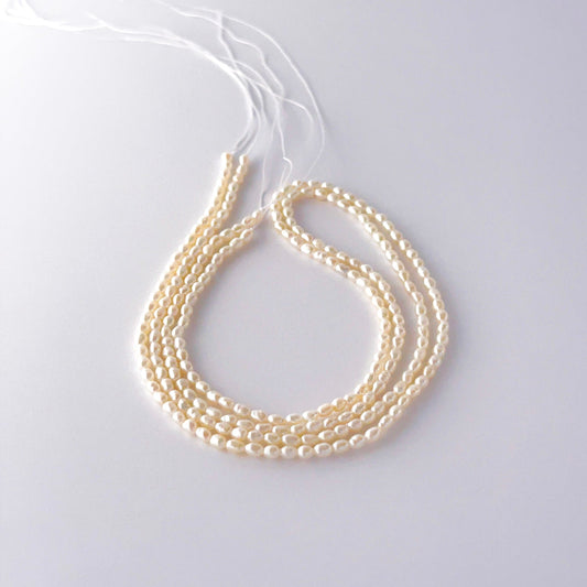 Small freshwater rice pearls arranged neatly, highlighting their smooth finish and handmade jewellery component quality