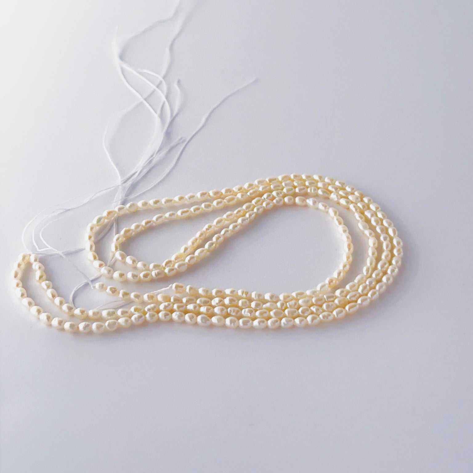 Freshwater rice pearls in a long strand, displaying consistent size and refined craftsmanship.