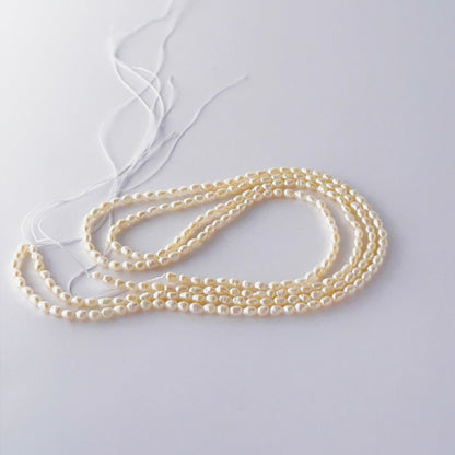 Freshwater rice pearls in a long strand, displaying consistent size and refined craftsmanship.