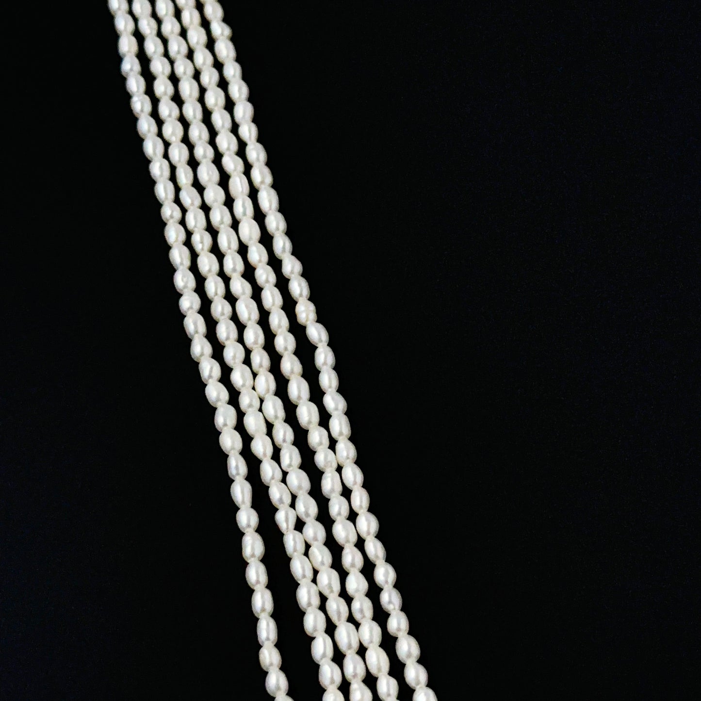 Freshwater rice pearls in 2.5–2.7mm size arranged neatly on a 38cm strand for DIY jewellery making.