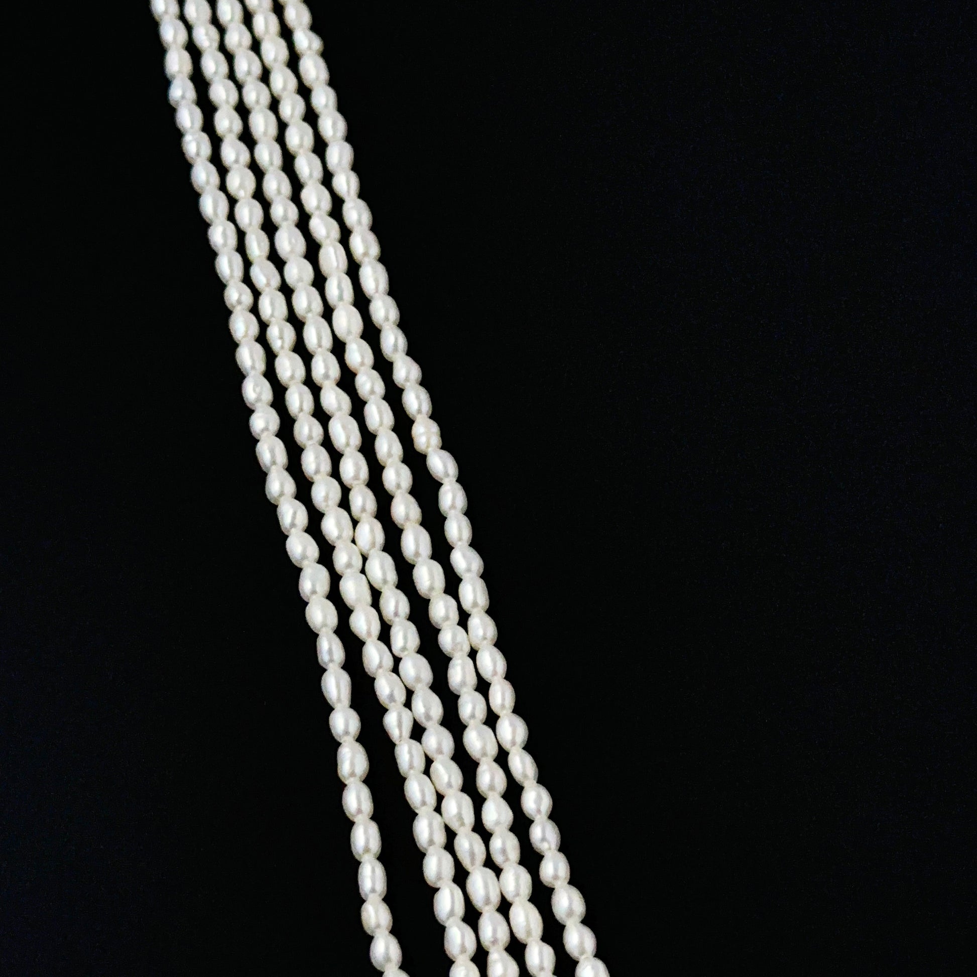 Freshwater rice pearls in 2.5–2.7mm size arranged neatly on a 38cm strand for DIY jewellery making.