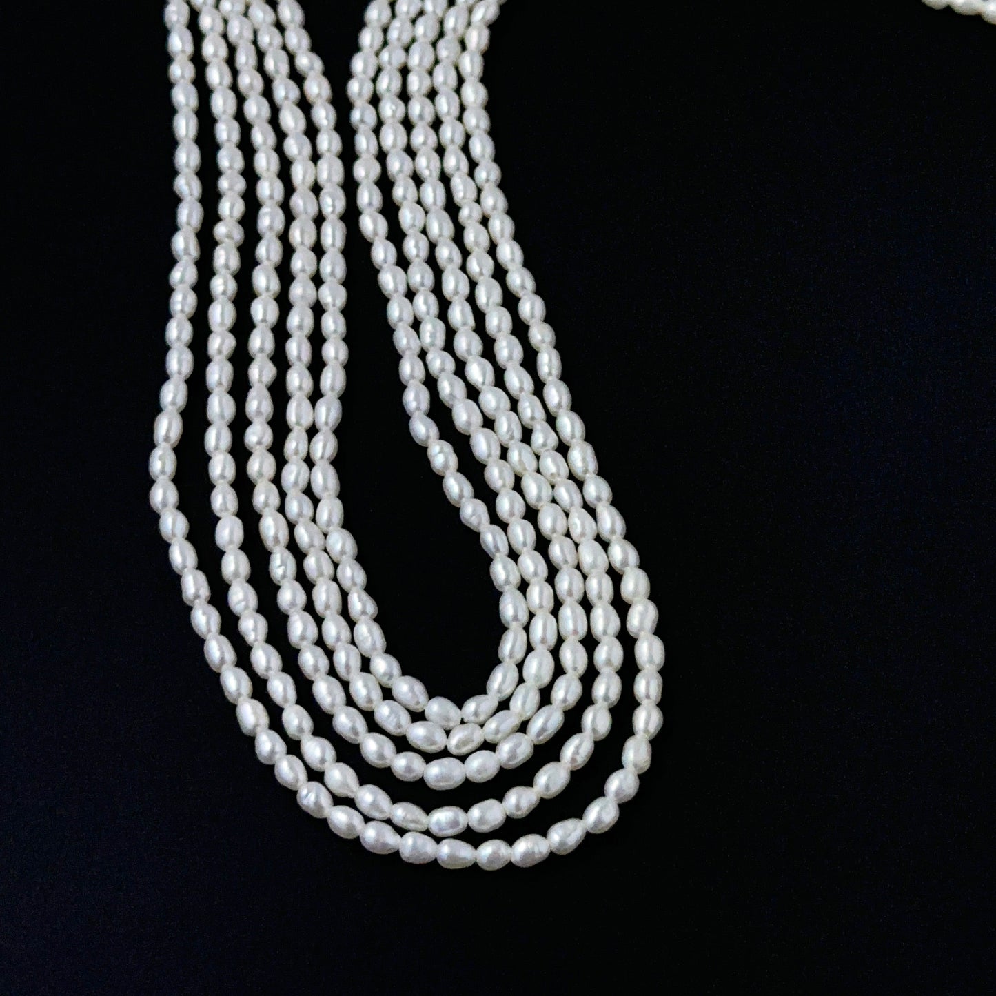 Smooth freshwater rice pearls showing soft lustre and consistent handmade jewellery component quality.