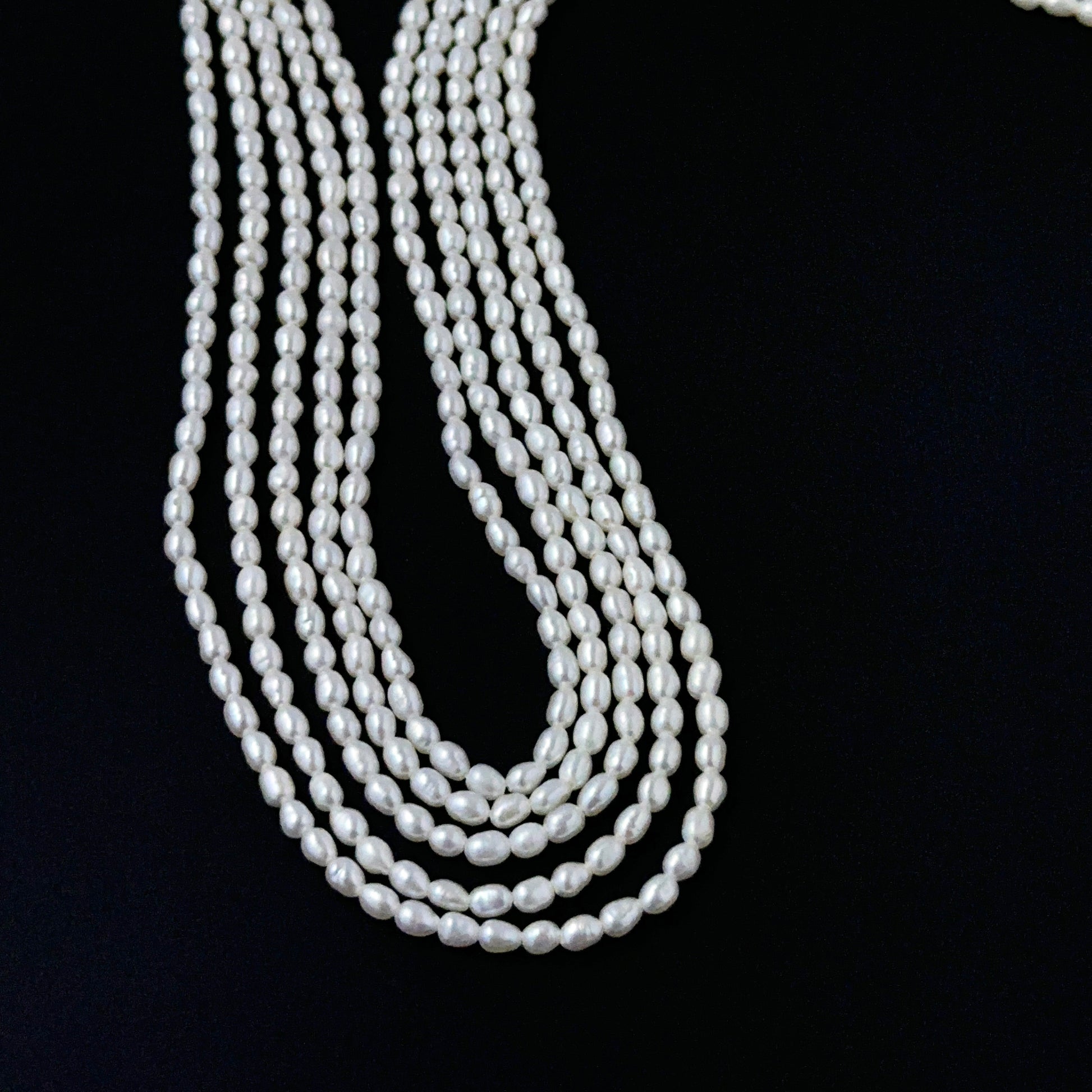 Smooth freshwater rice pearls showing soft lustre and consistent handmade jewellery component quality.