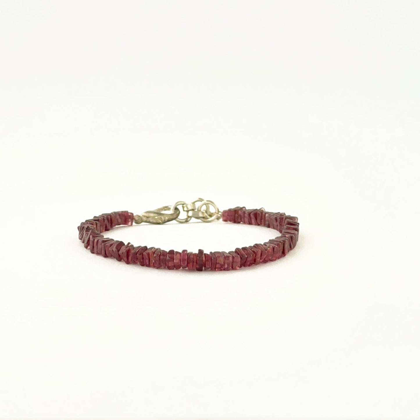 Elegant garnet bracelet showcasing 4–4.2mm square heishi beads.