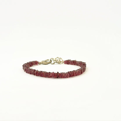 Elegant garnet bracelet showcasing 4–4.2mm square heishi beads.
