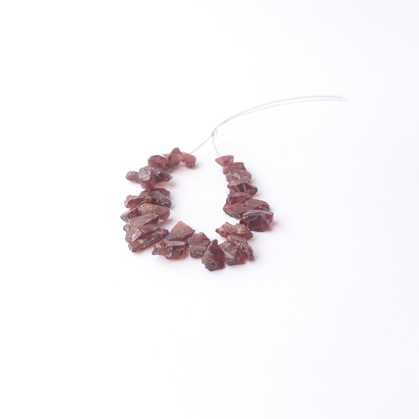 Genuine Garnet drilled rough gemstone beads showcasing deep red colour and natural raw texture.
