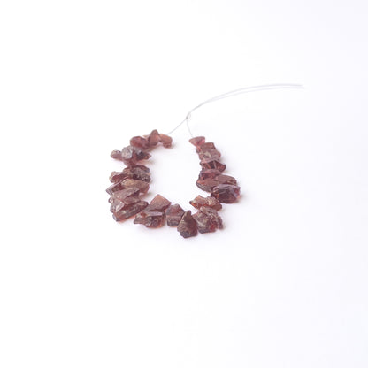 Genuine Garnet drilled rough gemstone beads showcasing deep red colour and natural raw texture.
