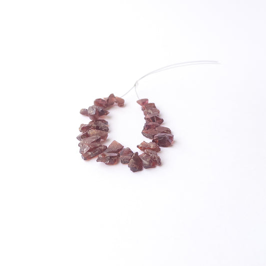 Genuine Garnet drilled rough gemstone beads showcasing deep red colour and natural raw texture.