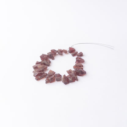 Garnet rough gemstone beads for DIY jewellery projects showing rugged surfaces and natural shine.