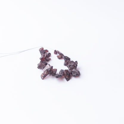 Genuine Garnet drilled rough gemstone beads showcasing deep red tones and natural raw sparkle.
