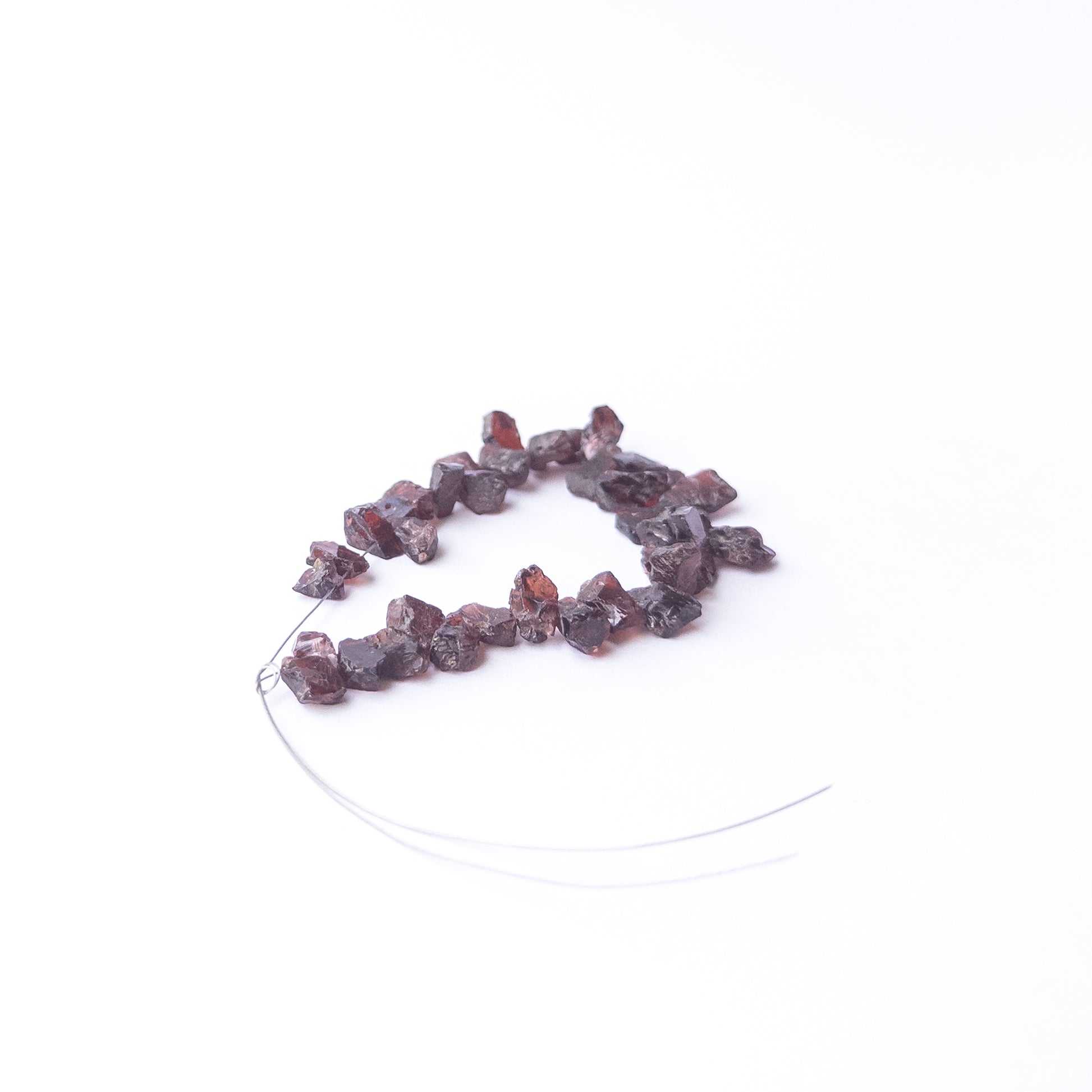 Garnet rough gemstone beads for DIY jewellery projects showing rugged surfaces and natural brilliance.