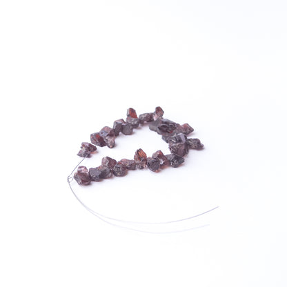 Garnet rough gemstone beads for DIY jewellery projects showing rugged surfaces and natural brilliance.
