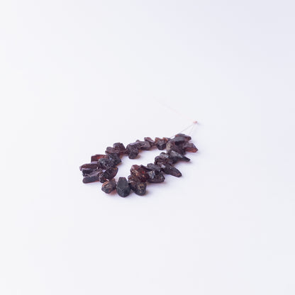 Genuine Garnet drilled rough gemstone beads showcasing deep red tones and natural raw texture.