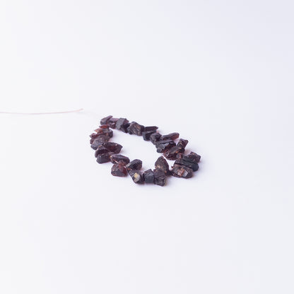Garnet rough gemstone beads for DIY jewellery projects showing rugged surfaces and natural shine.