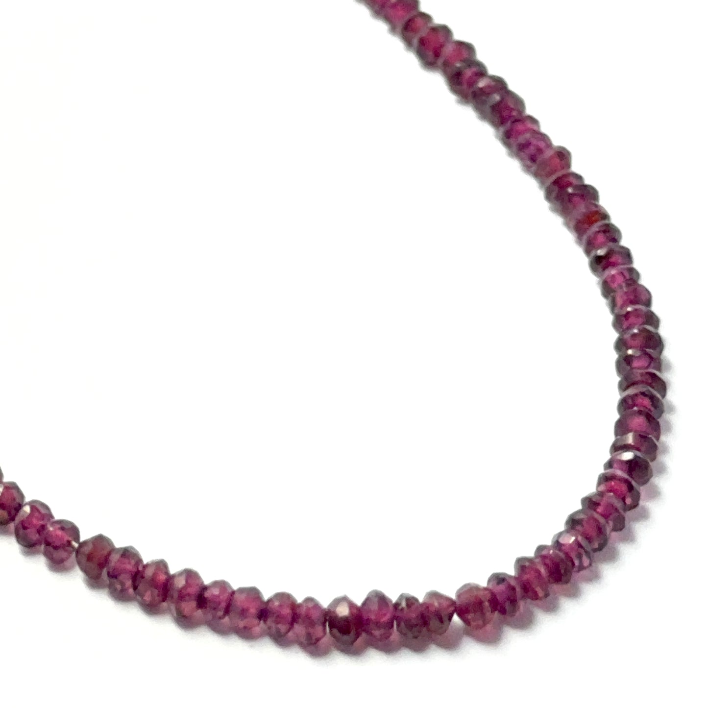 Garnet faceted rondelle beads with a glossy finish, arranged neatly on a strand for gemstone bead jewellery projects.