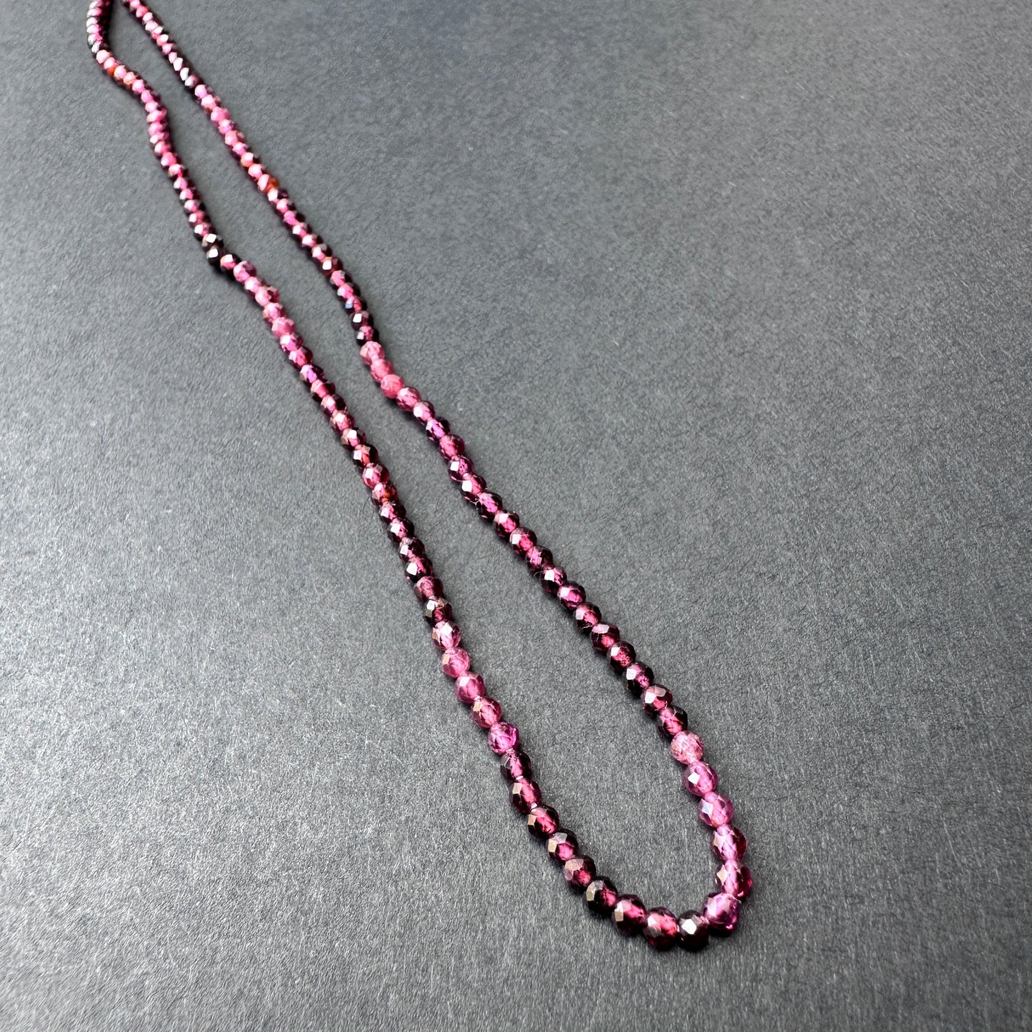 Handmade jewellery components showcasing garnet stone beads with sparkling facets and natural gemstone quality.