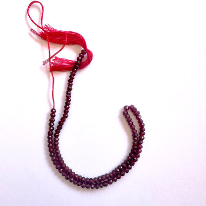 Close-up of Garnet beads showcasing their rich colour and faceted brilliance.