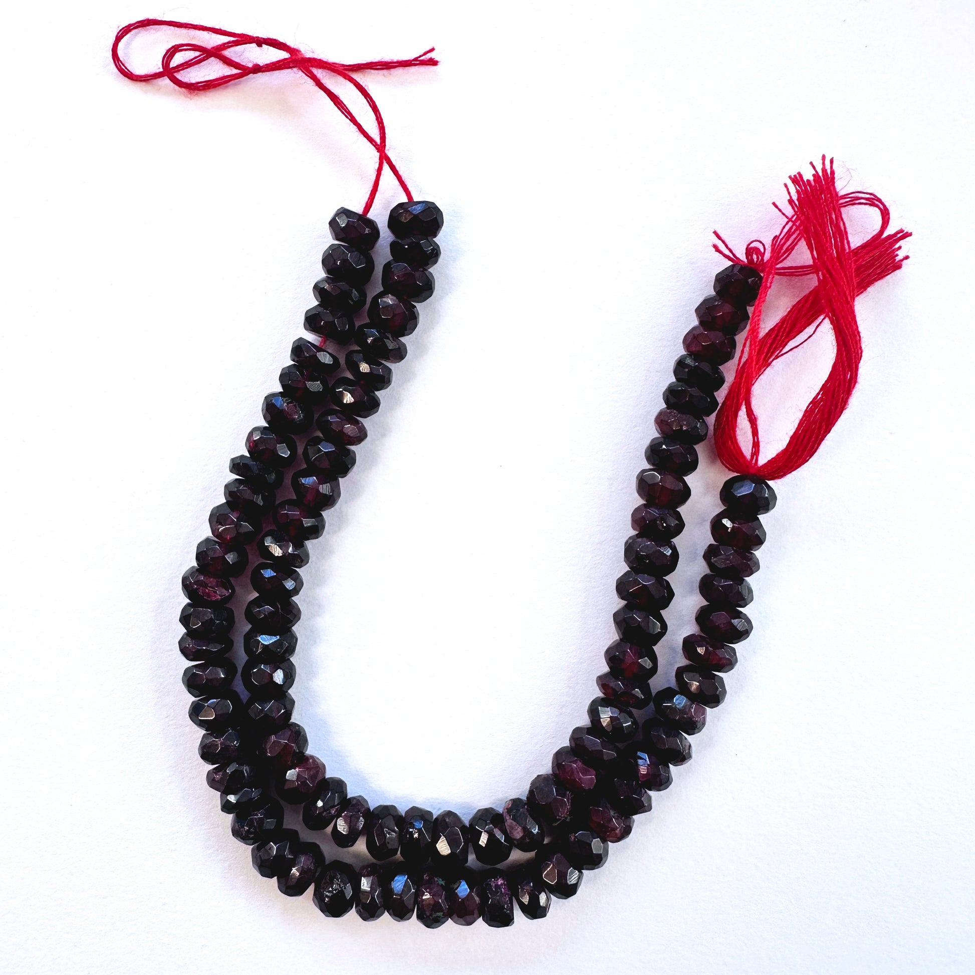 Garnet stone beads with precise faceted rondelle cut and consistent polish.