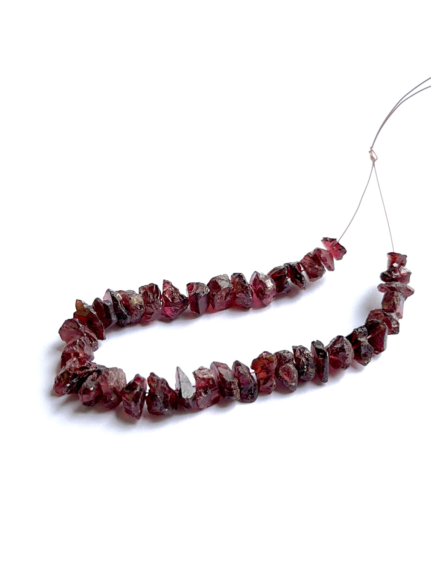 Raw garnet stones displayed with visible texture ideal for natural gemstone beads in jewellery making.