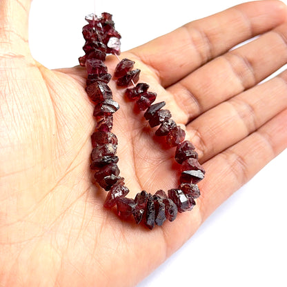 Close‑up of garnet rough stone beads highlighting their organic shape and rich colour for DIY jewellery.