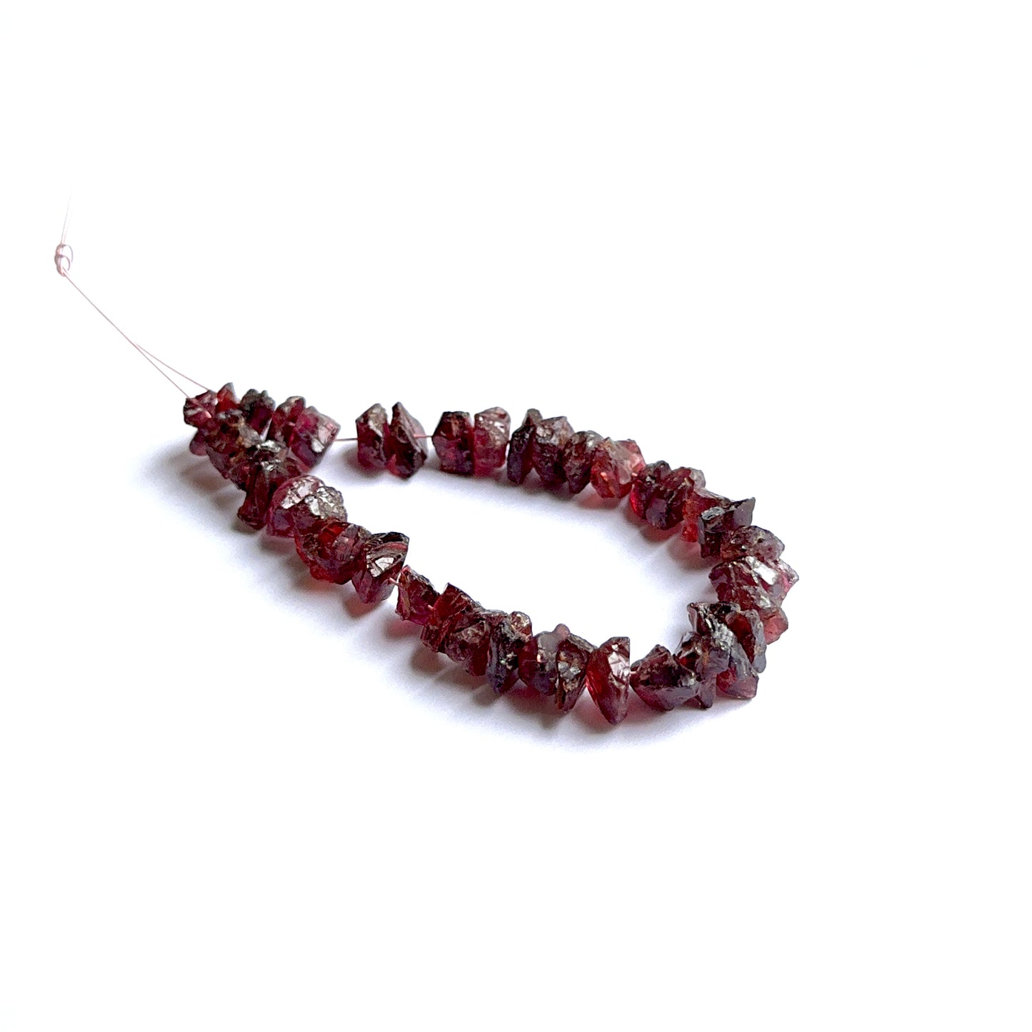 Garnet rough beads arranged neatly to showcase natural gemstone quality and handcrafted appeal.
