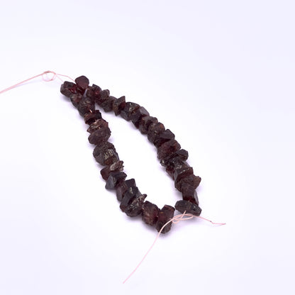 Handmade jewellery components featuring Garnet rough beads in rich red hues.