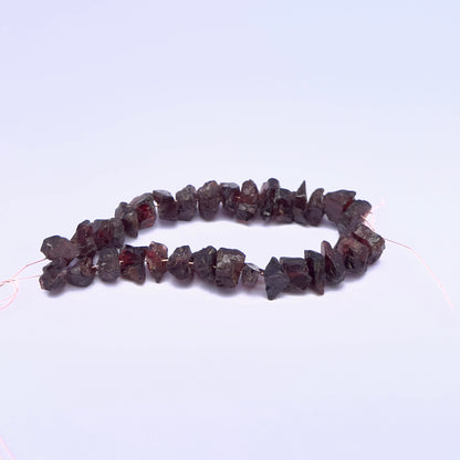 Garnet gemstone beads for handmade jewellery displayed with soft lighting.
