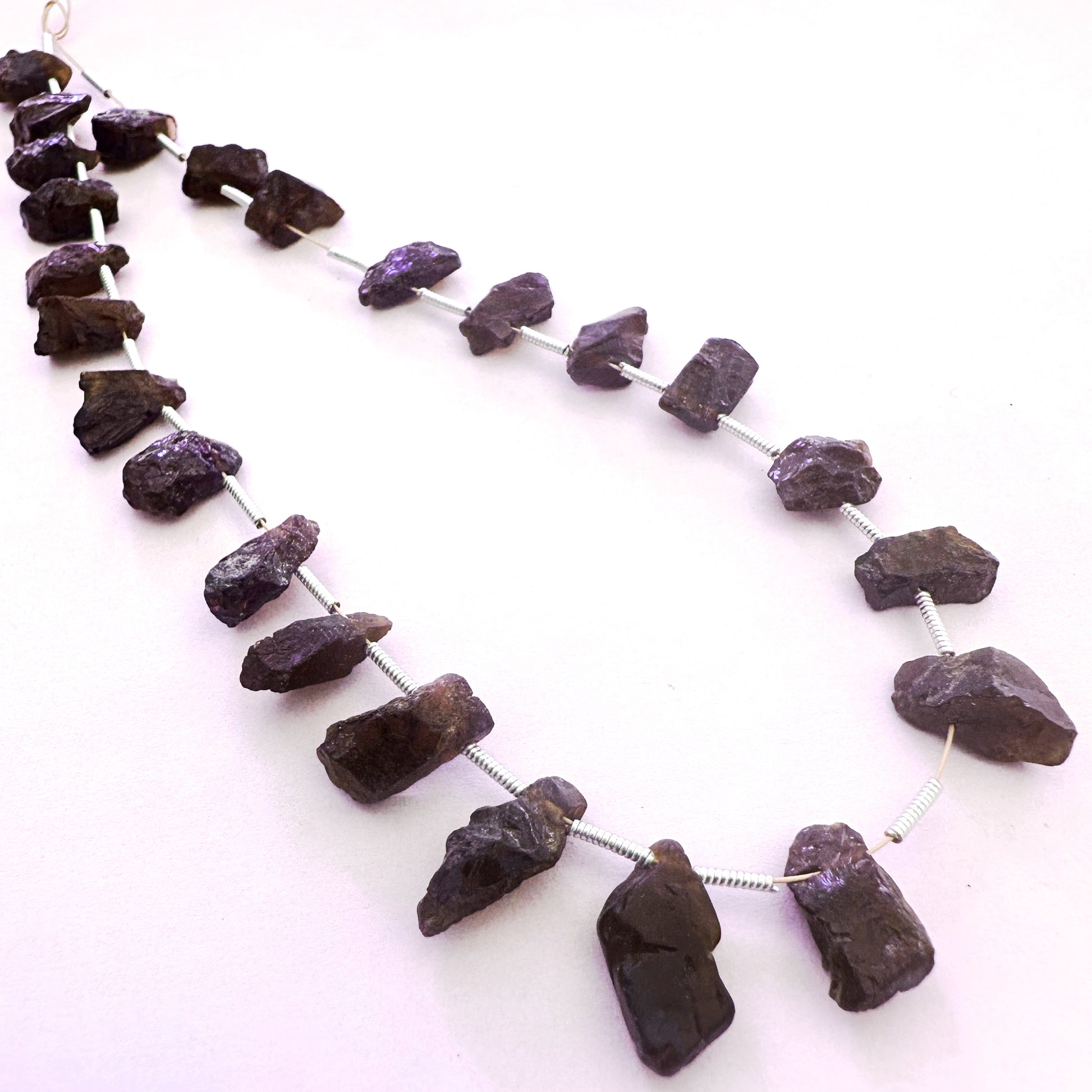 Arrangement of 24 Garnet beads with side-drilled holes and organic shapes in 6-7mm size.