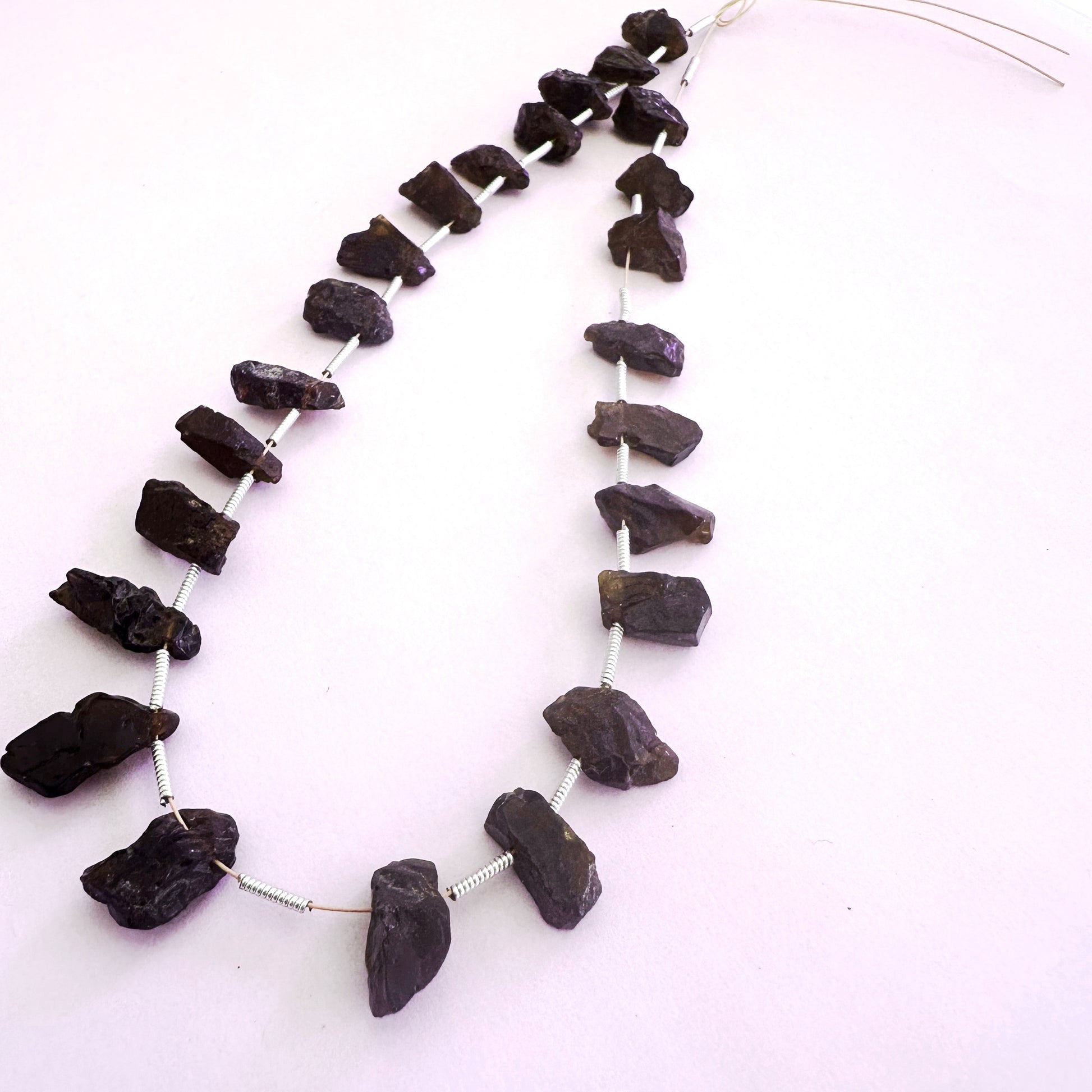 Garnet rough side-drilled beads in 6-7mm size with deep red tones and natural texture, 24 pieces totalling 84 carats.