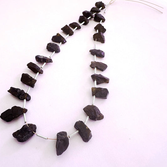 Garnet rough side-drilled beads in 6-7mm size with deep red tones and natural texture, 24 pieces totalling 84 carats.