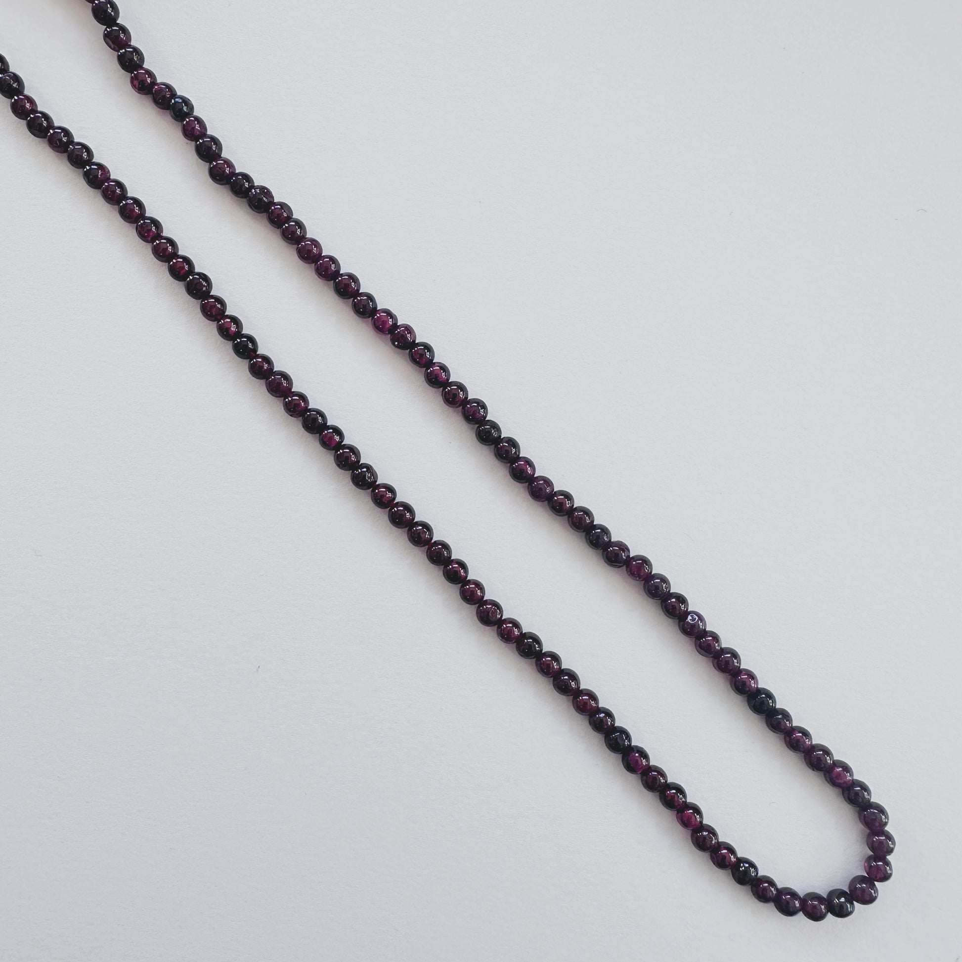 Garnet stone beads with smooth round cut and rich colour saturation.