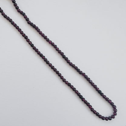 Garnet stone beads with smooth round cut and rich colour saturation.