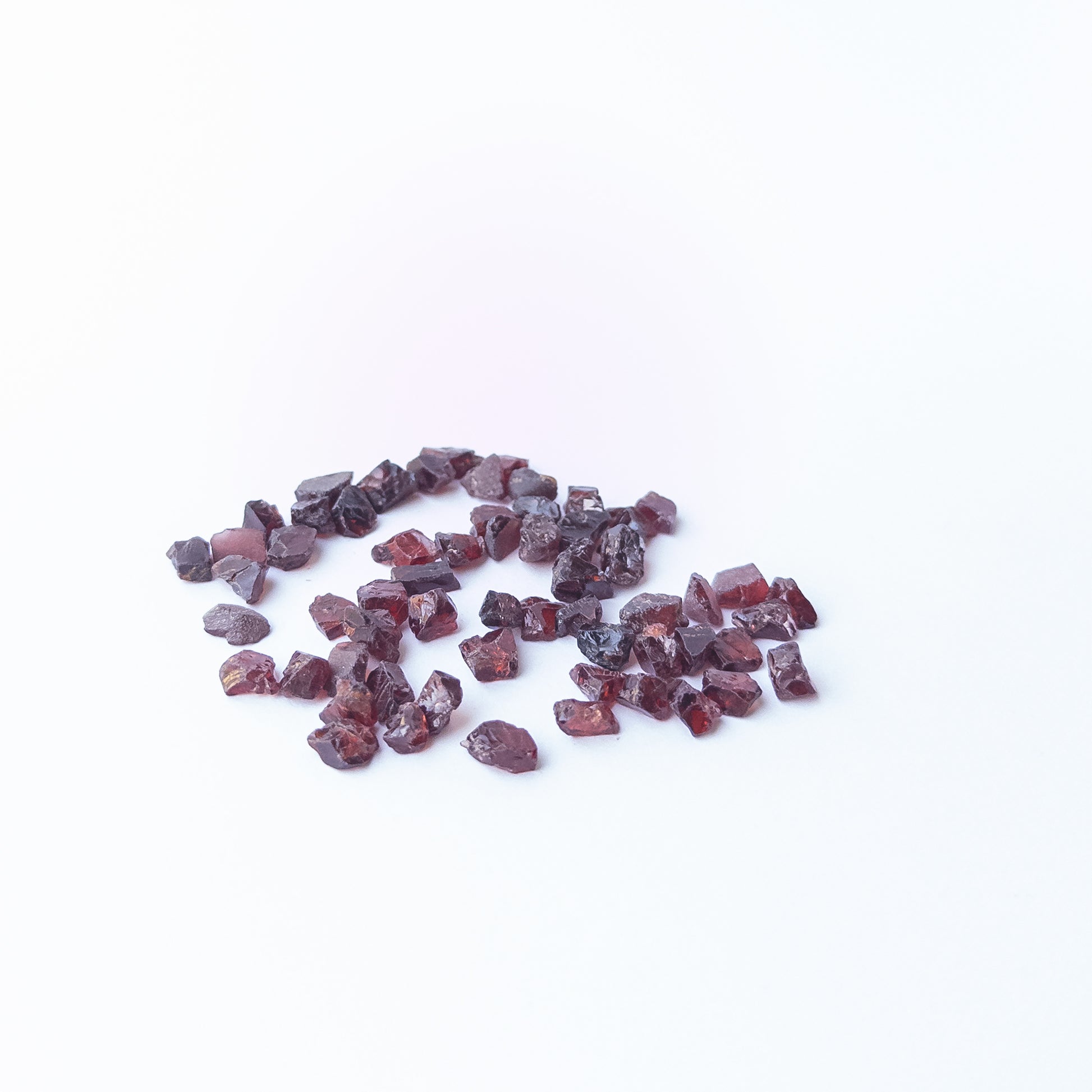 Vibrant Garnet rough stones with earthy red colour and raw texture for jewellery designers.