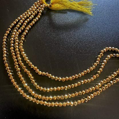 Close-up of 2.5mm gold pyrite beads arranged in a neat faceted rondelle formation.