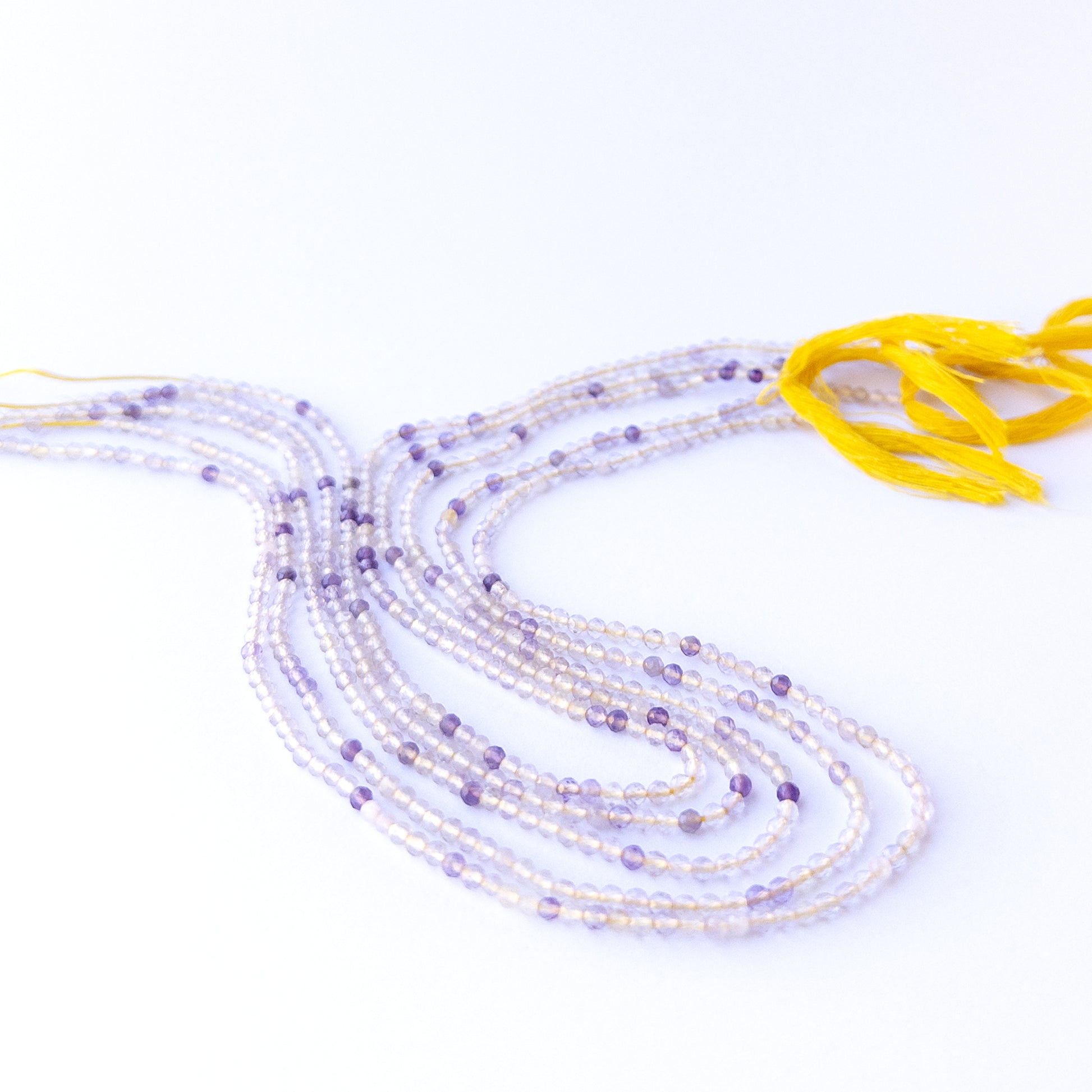 Handmade jewellery components featuring natural golden rutile faceted rondelles with warm tones and polished sparkle.