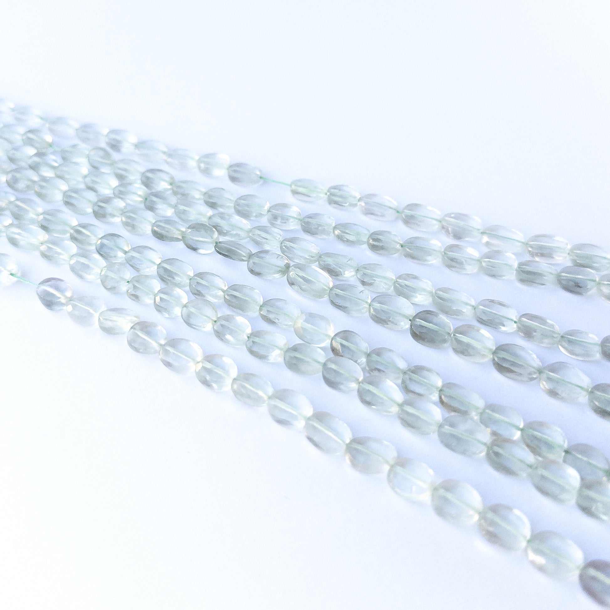 Handmade jewellery components featuring authentic Green Amethyst faceted oval beads with soft green sparkle.
