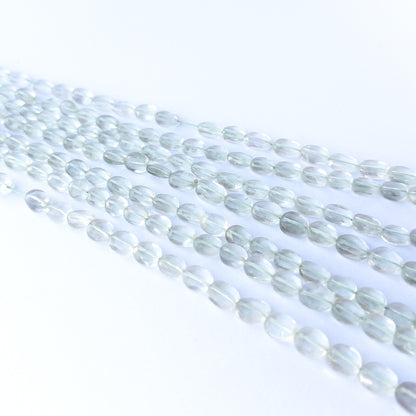 Handmade jewellery components featuring authentic Green Amethyst faceted oval beads with soft green sparkle.