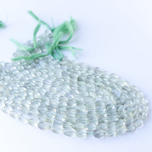 Natural Green Amethyst faceted oval stone beads 6–7mm displayed neatly for DIY jewellery and authentic gemstone bead designs.
