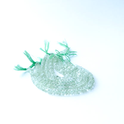 Close‑up of authentic Green Amethyst faceted rondelle beads showing their sparkle and consistent 5.5–6.5mm sizing.