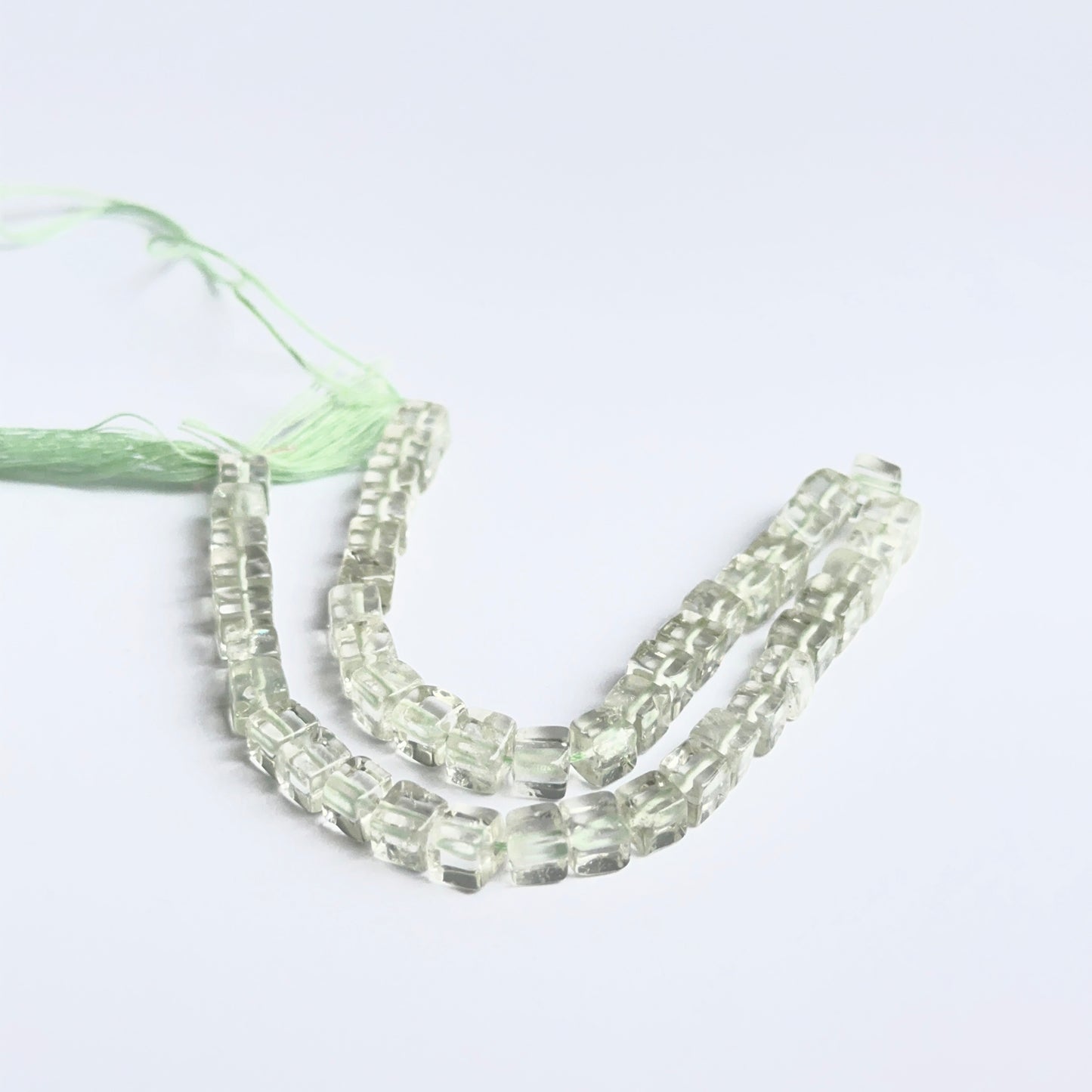 Green amethyst smooth cubes photographed to show clarity, soft colour and natural gemstone beauty.