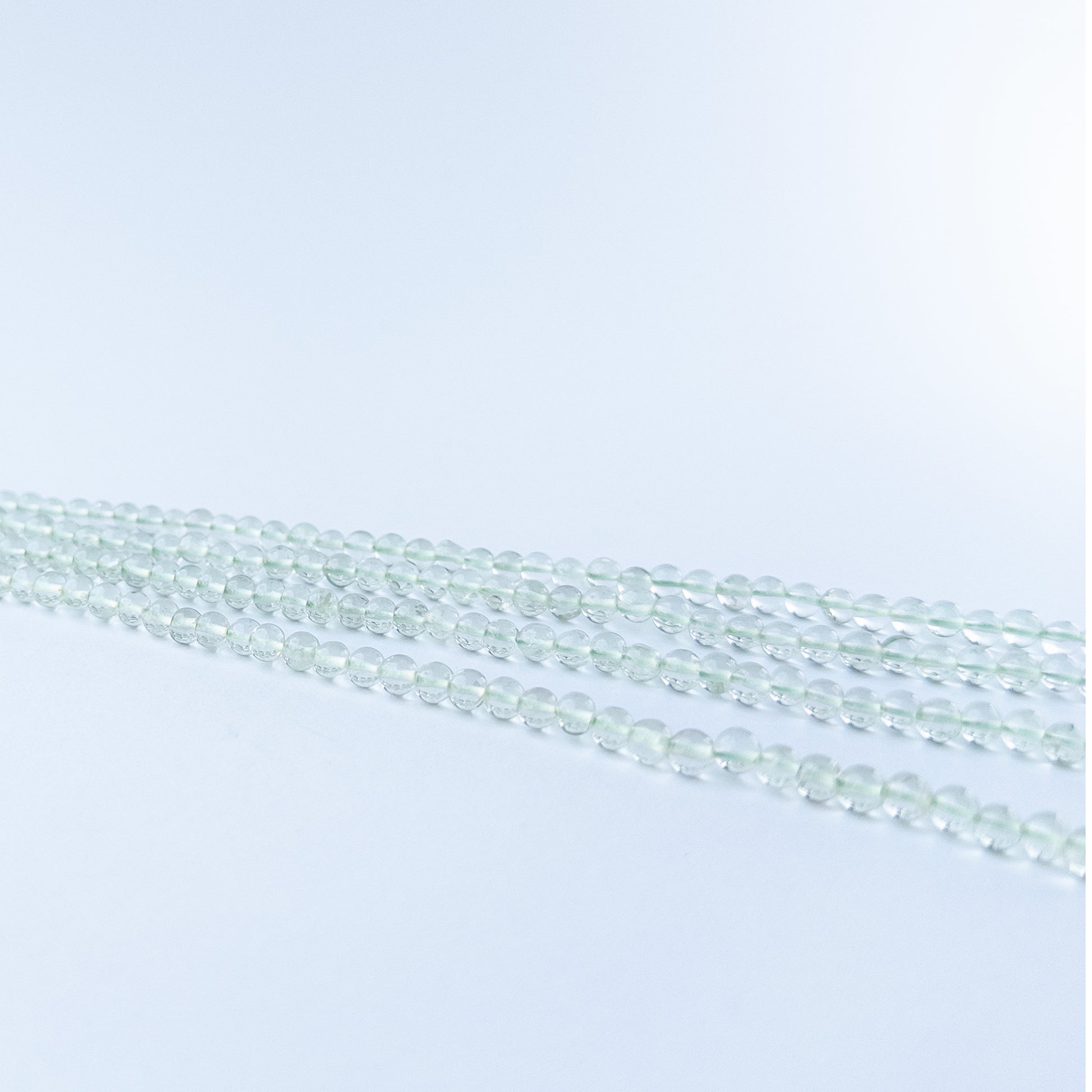 Authentic Green Amethyst gemstone beads showcasing gentle green colour, smooth round shaping and premium bead quality for jewellery designers.