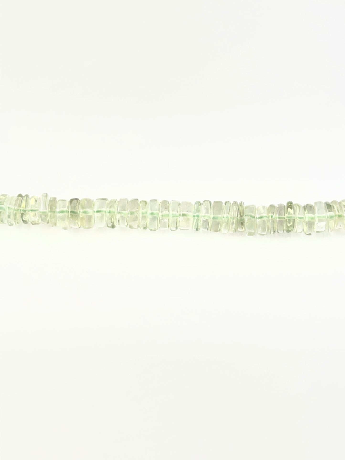 Light green amethyst wheel beads in 6.5–7.0mm sizing on a 21cm strand.