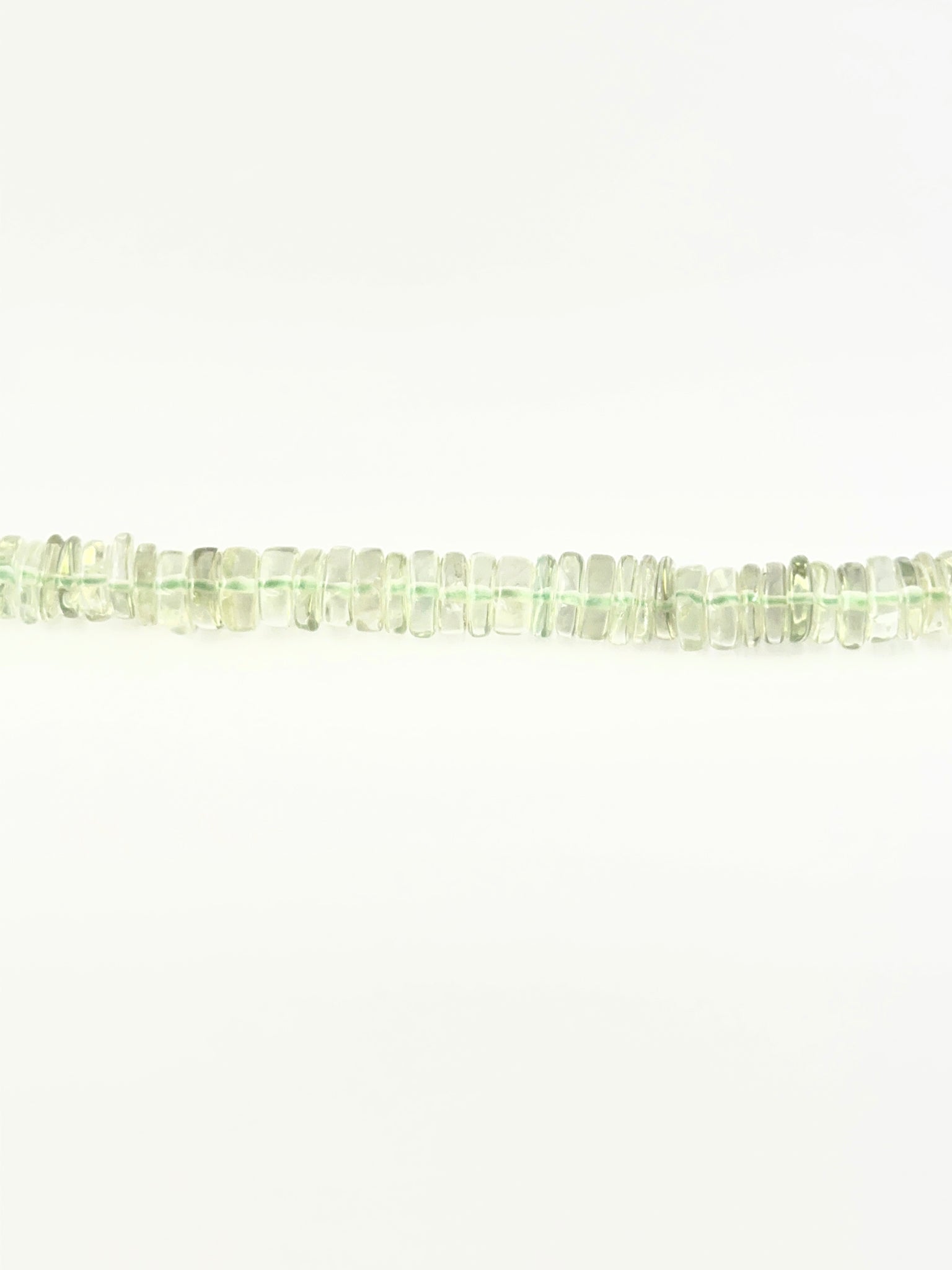 Light green amethyst wheel beads in 6.5–7.0mm sizing on a 21cm strand.