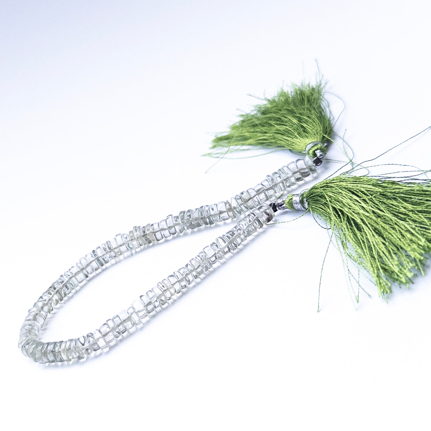 High‑quality Green Amethyst wheel beads displaying subtle green colour and smooth finish.