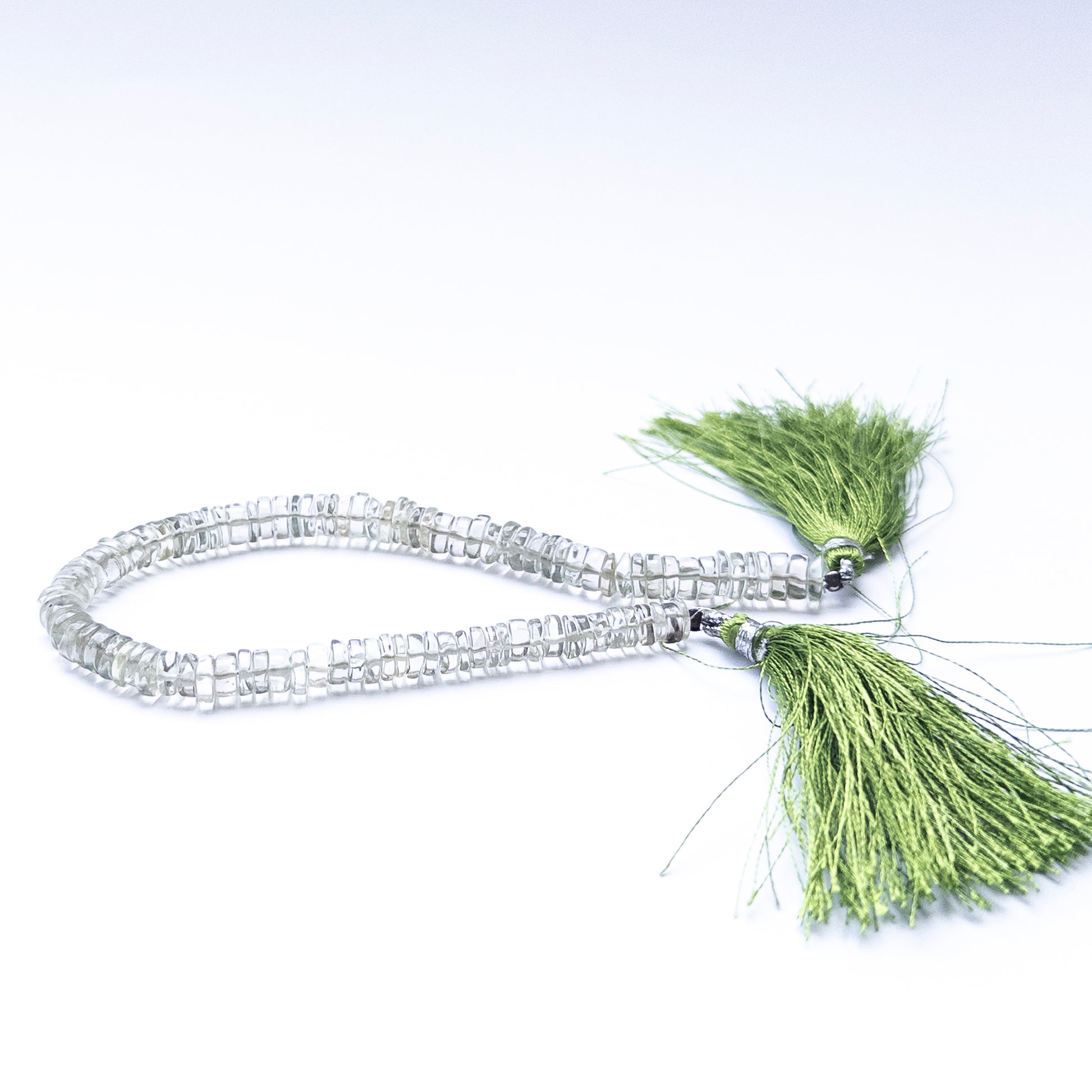Green Amethyst smooth wheels arranged neatly, highlighting their 6–6.5mm size.