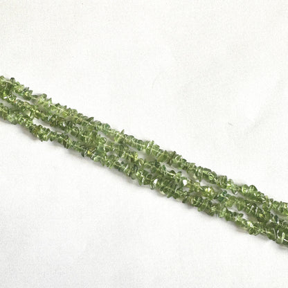 Smooth Green Apatite chip beads with translucent green tones on a 22cm strand.