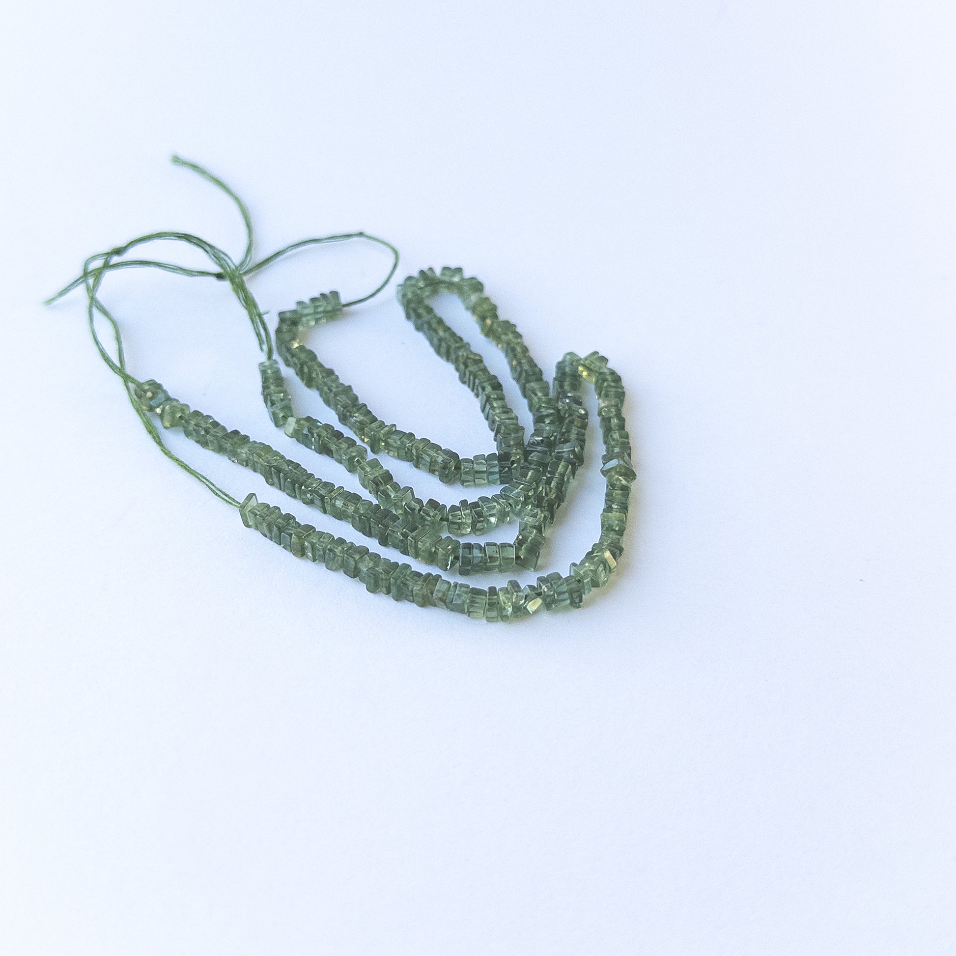 Genuine green apatite stone beads with polished smooth heishi shaping, ideal for DIY jewellery and artisan beadwork.
