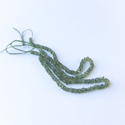 Authentic green apatite gemstone beads showcasing vibrant green tones and uniform heishi cut.