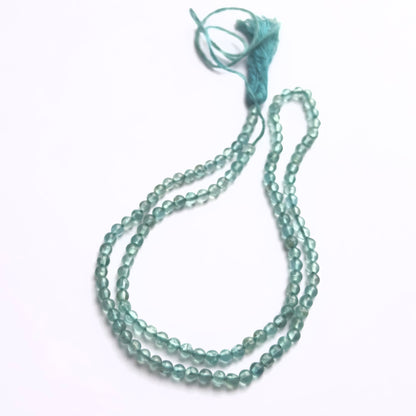Apatite smooth round beads in vibrant blue-green tones strung in a 33cm strand.