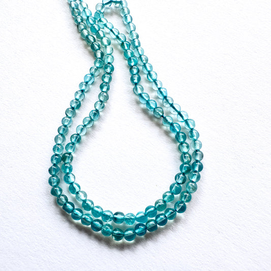 Natural gemstone beads in vibrant green tones, precision-cut and polished for jewellery making.